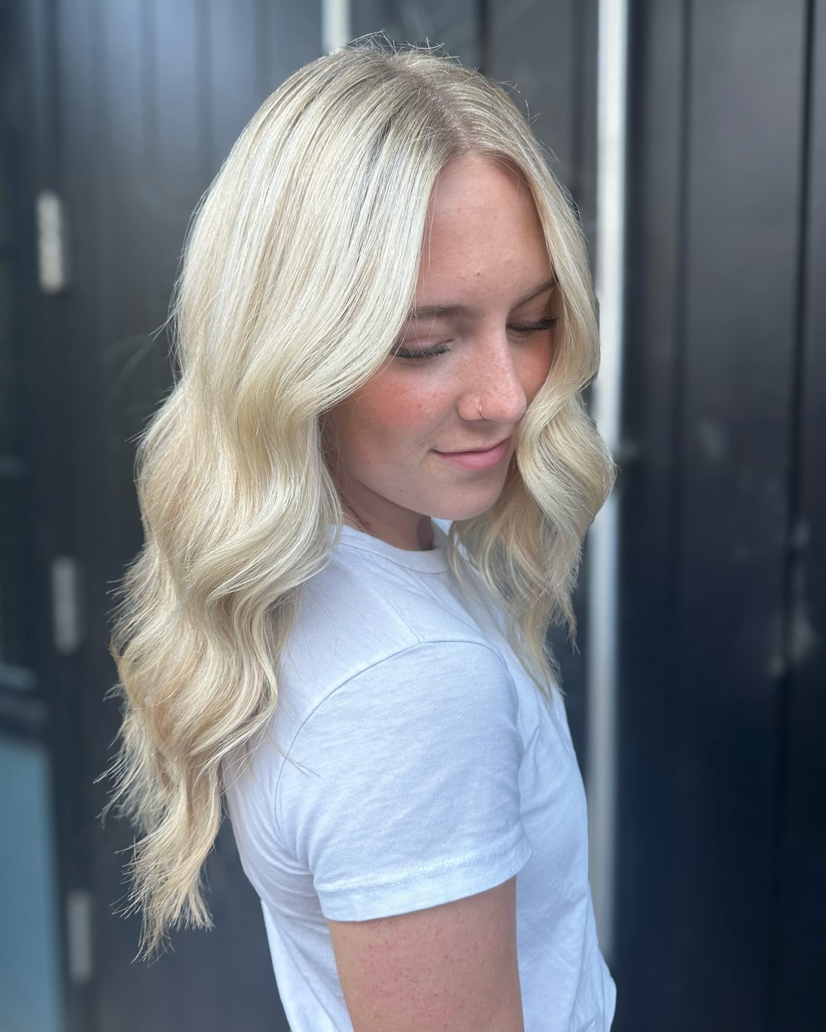 Bright, icy platinum blonde with a smooth blend, styled in loose waves
